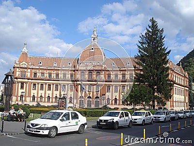 Prefecture building and line of standing cabs on the street in center of Brasov Editorial Stock Photo