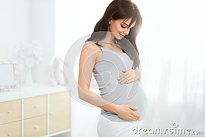 Pregnancy. Beautiful Smiling Pregnant Woman Stock Photo