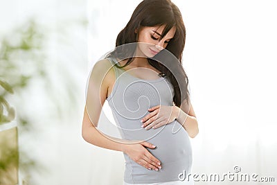 Pregnancy. Beautiful Smiling Pregnant Woman Stock Photo