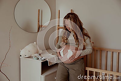 Pregnancy, family, love, woman holding tiny socks for baby Stock Photo