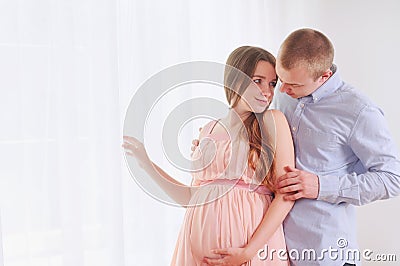 Pregnancy and lovely couple at home Stock Photo