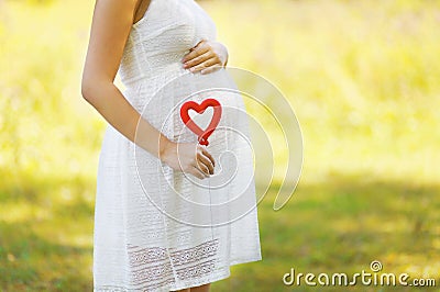 Pregnancy, maternity, family - concept, pregnant woman and heart Stock Photo