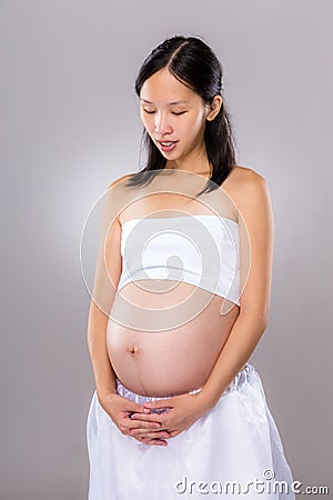 Pregnancy mother look at her belly Stock Photo