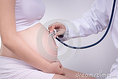 Pregnancy, motherhood, people, medicine and fertility concept - happy pregnant woman with doctor at maternity hospital. Stock Photo