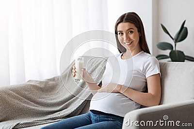 Pregnancy Nutrition. Happy Young Pregnant Woman With Glass Of Milk In Hand Stock Photo