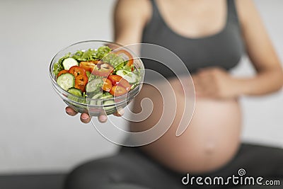 Pregnancy Nutrition. Unrecognizable Pregnant Woman Holding Bowl With Fresh Vegetable Salad Stock Photo