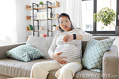pregnant woman having labor contractions at home Stock Photo