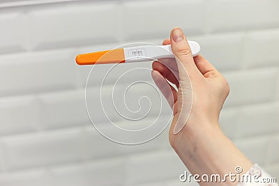 Rapid pregnancy test with positive result in woman`s hand, close up view. Human chorionic gonadotropin test Stock Photo