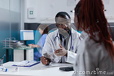 Pregnant adult receiving bottle of pills from medic Stock Photo