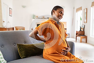 Pregnant african american woman having backache during gestation Stock Photo