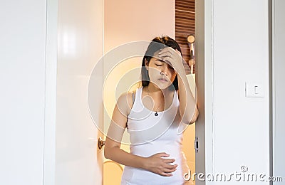 Pregnant female nausea in room,Hand woman touching her belly with morning sickness Stock Photo