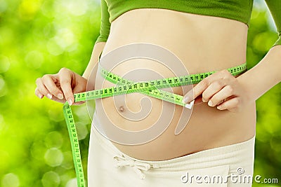Pregnant belly, woman measure stomach. Prenatal health care Stock Photo