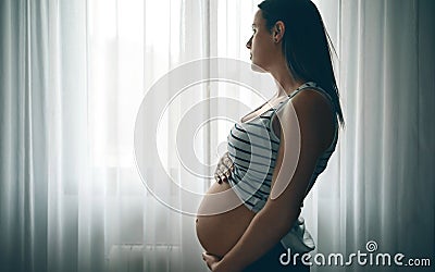 Pregnant caressing her nacked belly Stock Photo