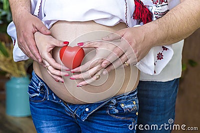 Pregnant couple choosing gender of the baby, the child`s name. The problem of choice for a husband and wife Stock Photo