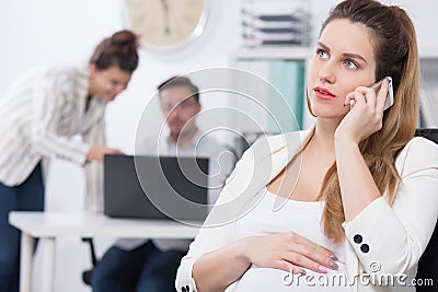 Pregnant exec and business call Stock Photo