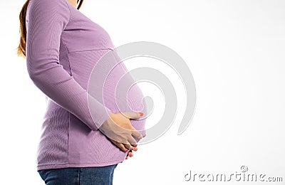 Pregnant girl in a purple sweater on a white background. The concept of weight gain during pregnancy. Overweight. Copy Stock Photo