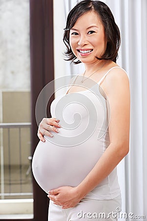 Pregnant lady caress her stomach Stock Photo