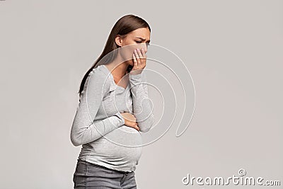 Pregnant Lady Feeling Sick Having Nausea Standing On Gray Background Stock Photo