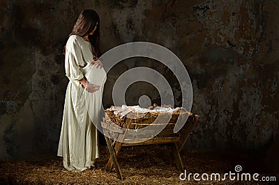 Pregnant Mary Looking at the Manger Stock Photo