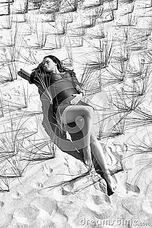Pregnant model posing on the sandy background bw Stock Photo