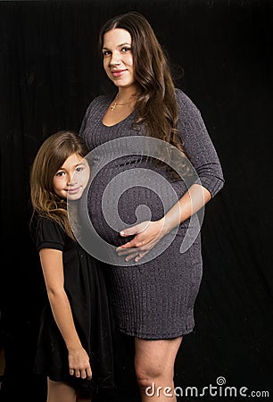 Pregnant mom and daughter Stock Photo