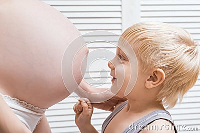 Pregnant mom and eldest son. Pregnancy preparation and expectation concept Stock Photo
