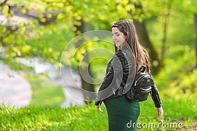 Pregnant schoolgirl. Attractive pregnant woman in dress schoolgirl posing on the street. Long-haired pregnant woman walking down Stock Photo