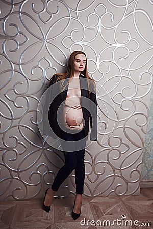 Pregnant skinny women model in business office style cloth topless Stock Photo