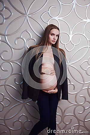 Pregnant skinny women model in business office style cloth topless Stock Photo