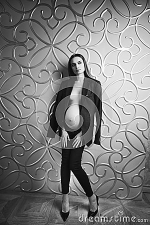 Pregnant skinny women model in business office style cloth topless Stock Photo