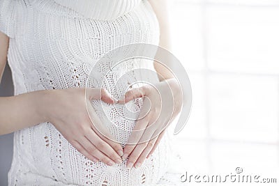 Pregnant woman belly, pregnancy heart shape, love sign Stock Photo