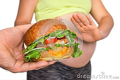 Pregnant woman with belly refused to eat a burger Stock Photo