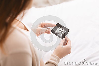 Pregnant woman caressing her belly with sonography Stock Photo