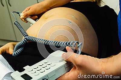 Pregnant woman checked by midwife Stock Photo