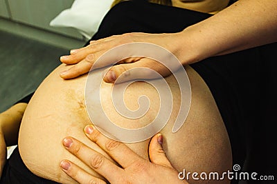 Pregnant woman checked by midwife Stock Photo