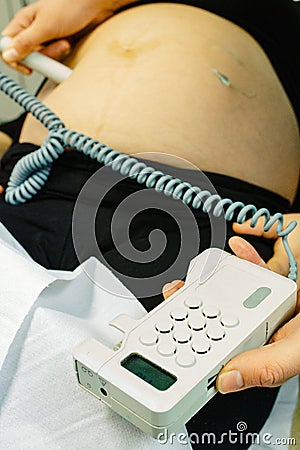 Pregnant woman checked by midwife Stock Photo