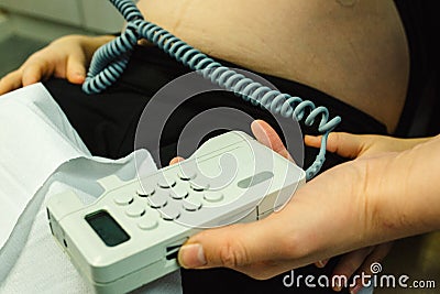 Pregnant woman checked by midwife Stock Photo