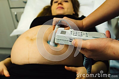 Pregnant woman checked by midwife Stock Photo