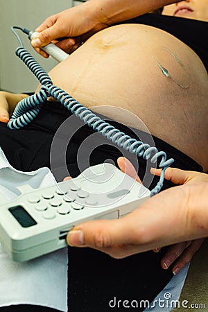 Pregnant woman checked by midwife Stock Photo