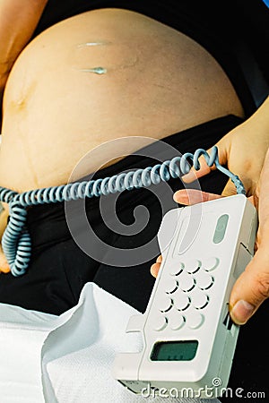 Pregnant woman checked by midwife Stock Photo