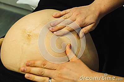 Pregnant woman checked by midwife Stock Photo