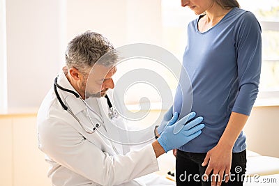 Pregnant Woman At Chiropractor. Baby Breech Physiotherapy Stock Photo