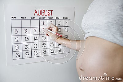 Pregnant woman counting down for delivery date Stock Photo