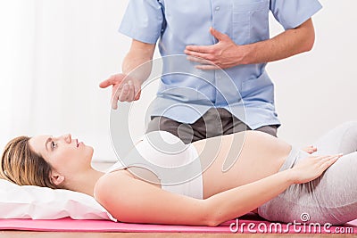 Pregnant woman doing breathing exercise Stock Photo