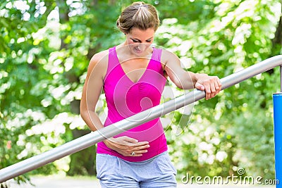 Pregnant woman doing pregnancy exercises on Fitness-Trail Stock Photo