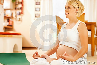 Pregnant woman doing pregnancy yoga Stock Photo
