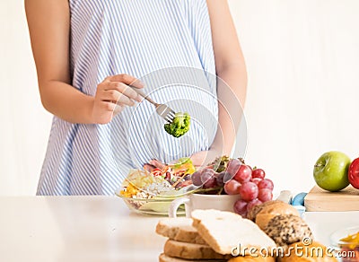 Pregnant woman eating healthy fresh salad,healthy nutrition during pregnancy Stock Photo