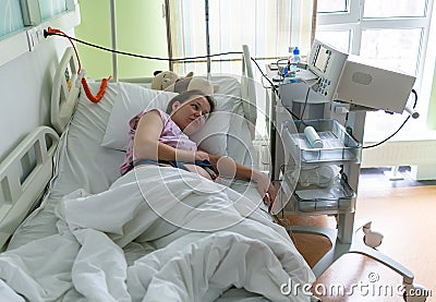 Pregnant woman feels hard contraction in a hospital labor delivery room. Concept photo of pregnancy, pregnant woman Stock Photo