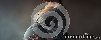 A Pregnant Woman Gently Cradles Her Prominent Belly During The Final Months Of Pregnancy Radiating Maternal Grace Stock Photo