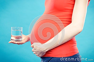 Pregnant woman with glass of water, healthy lifestyle and hydration in pregnancy Stock Photo